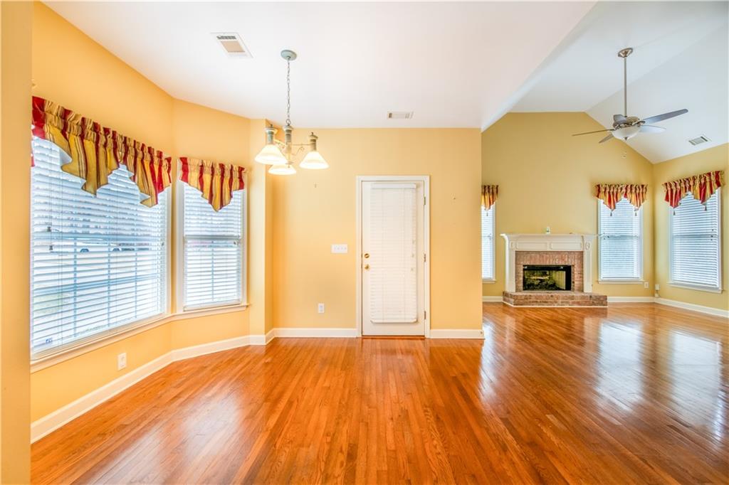 4924 Hugh Howell Road Stone Mountain, GA 30087 - Photo 12 of 42 a view of a room with wooden floor fireplace and windows