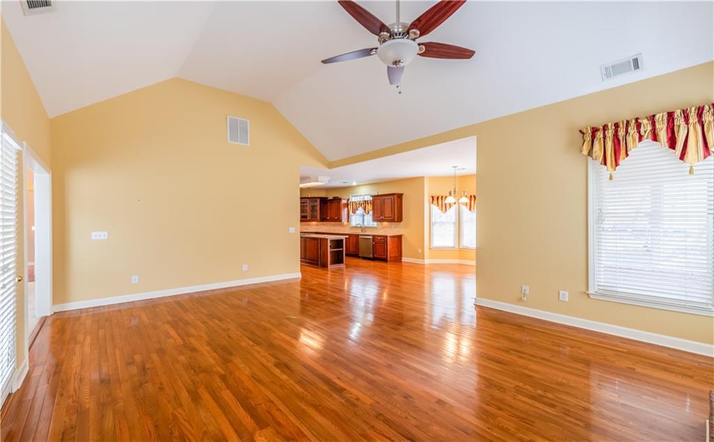 4924 Hugh Howell Road Stone Mountain, GA 30087 - Photo 14 of 42 a view of an empty room with wooden floor and a window