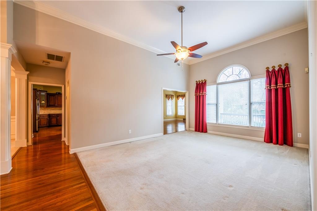 4924 Hugh Howell Road Stone Mountain, GA 30087 - Photo 15 of 42 a view of empty room with a fireplace and wooden floor