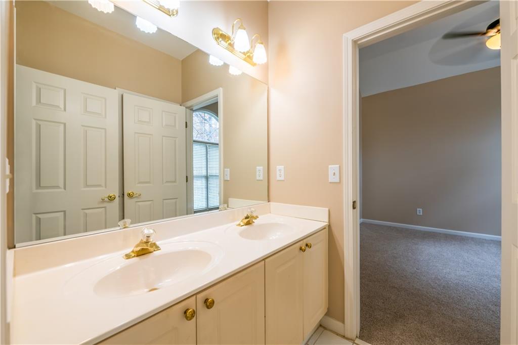 4924 Hugh Howell Road Stone Mountain, GA 30087 - Photo 17 of 42 a bathroom with a sink and a mirror
