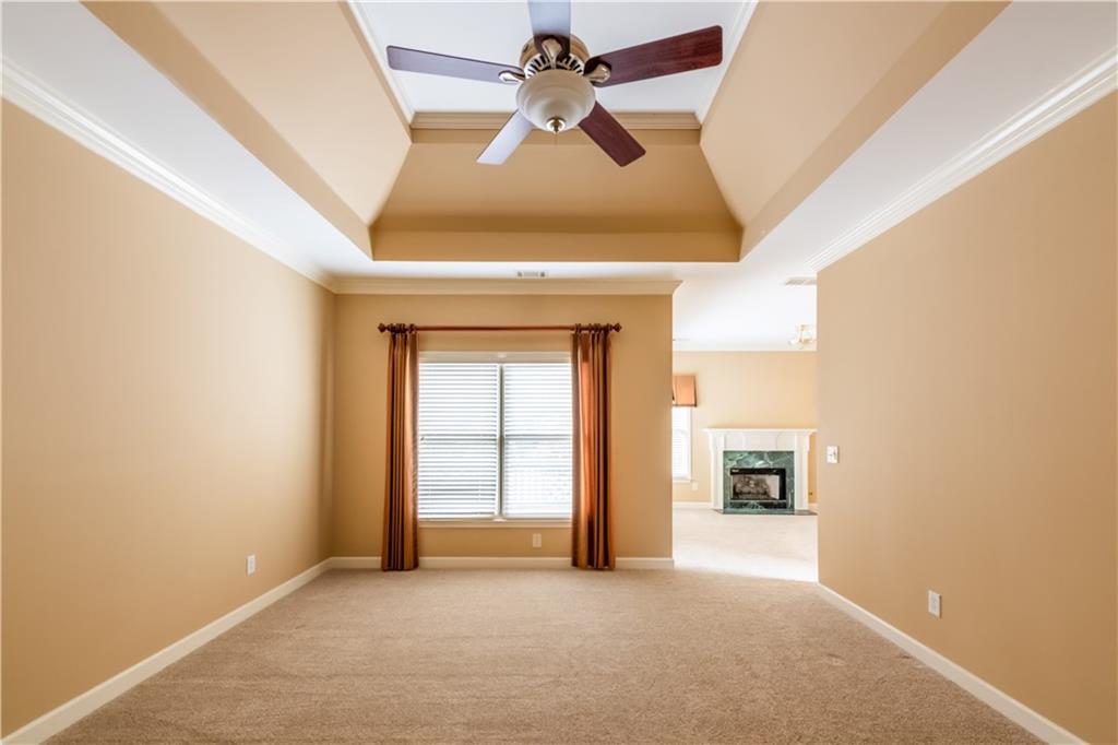 4924 Hugh Howell Road Stone Mountain, GA 30087 - Photo 20 of 42 an empty room with chandelier fan