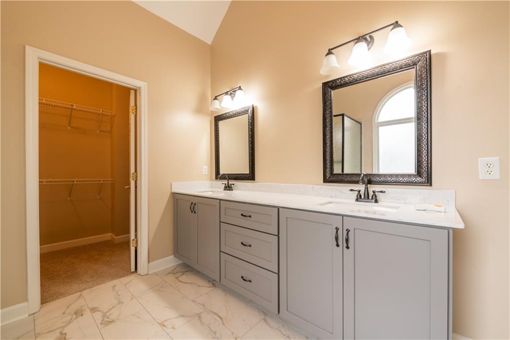 4924 Hugh Howell Road Stone Mountain, GA 30087 - Photo 25 of 42 a bathroom with a double vanity sink and a mirror