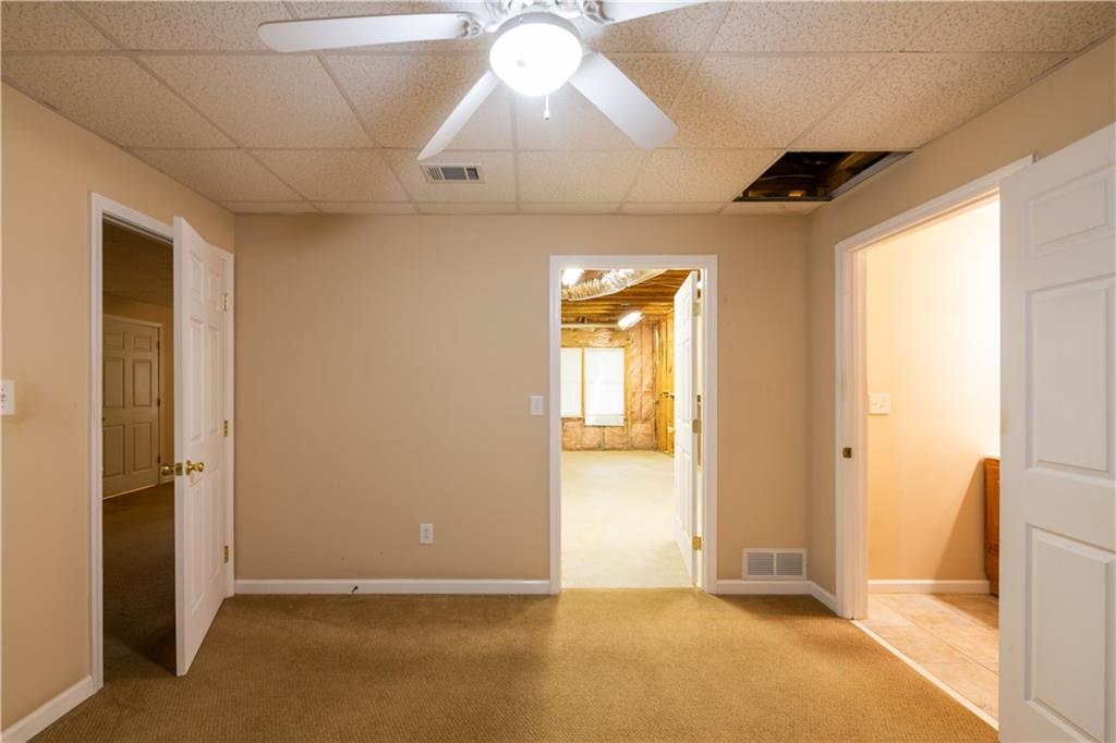 4924 Hugh Howell Road Stone Mountain, GA 30087 - Photo 30 of 42 an empty room with windows and closet