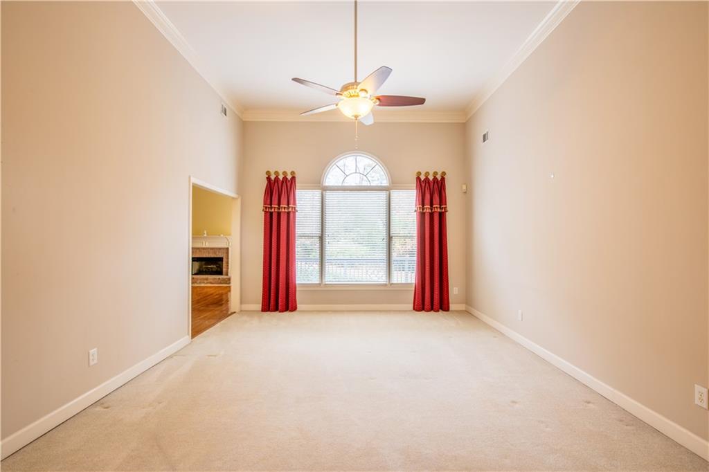 4924 Hugh Howell Road Stone Mountain, GA 30087 - Photo 4 of 42 a view of a livingroom with a ceiling fan and window