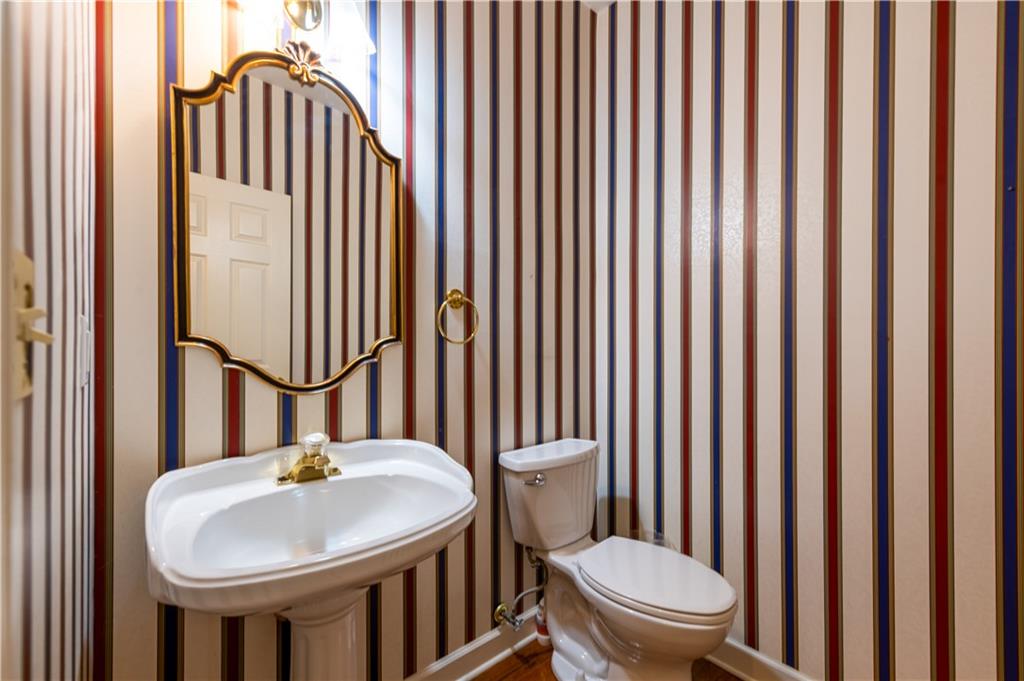 4924 Hugh Howell Road Stone Mountain, GA 30087 - Photo 7 of 42 a bathroom with a sink a toilet and mirror