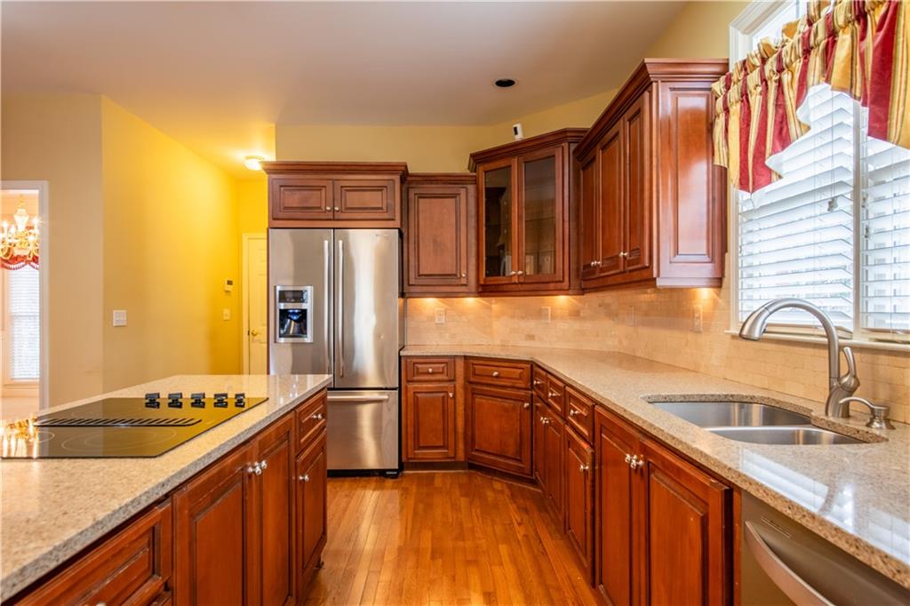 4924 Hugh Howell Road Stone Mountain, GA 30087 - Photo 10 of 42 a kitchen with stainless steel appliances granite countertop a sink stove and refrigerator