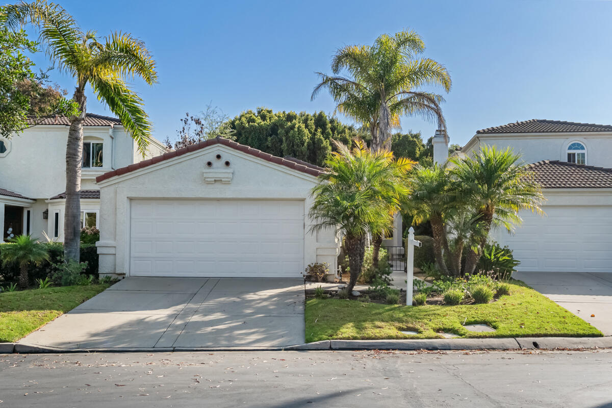 2110 Bermuda Dunes Place Oxnard, CA 93036 - Photo 1 of 43 a front view of a house with a yard and garage