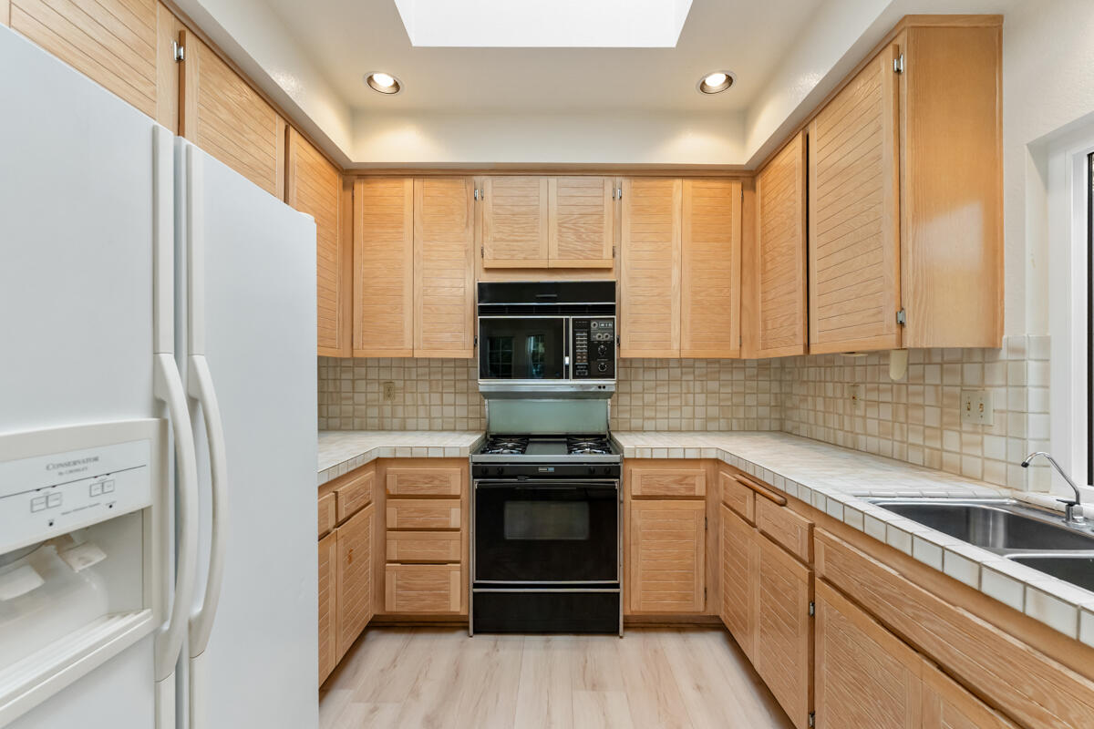 2110 Bermuda Dunes Place Oxnard, CA 93036 - Photo 17 of 43 a kitchen with a refrigerator and a sink