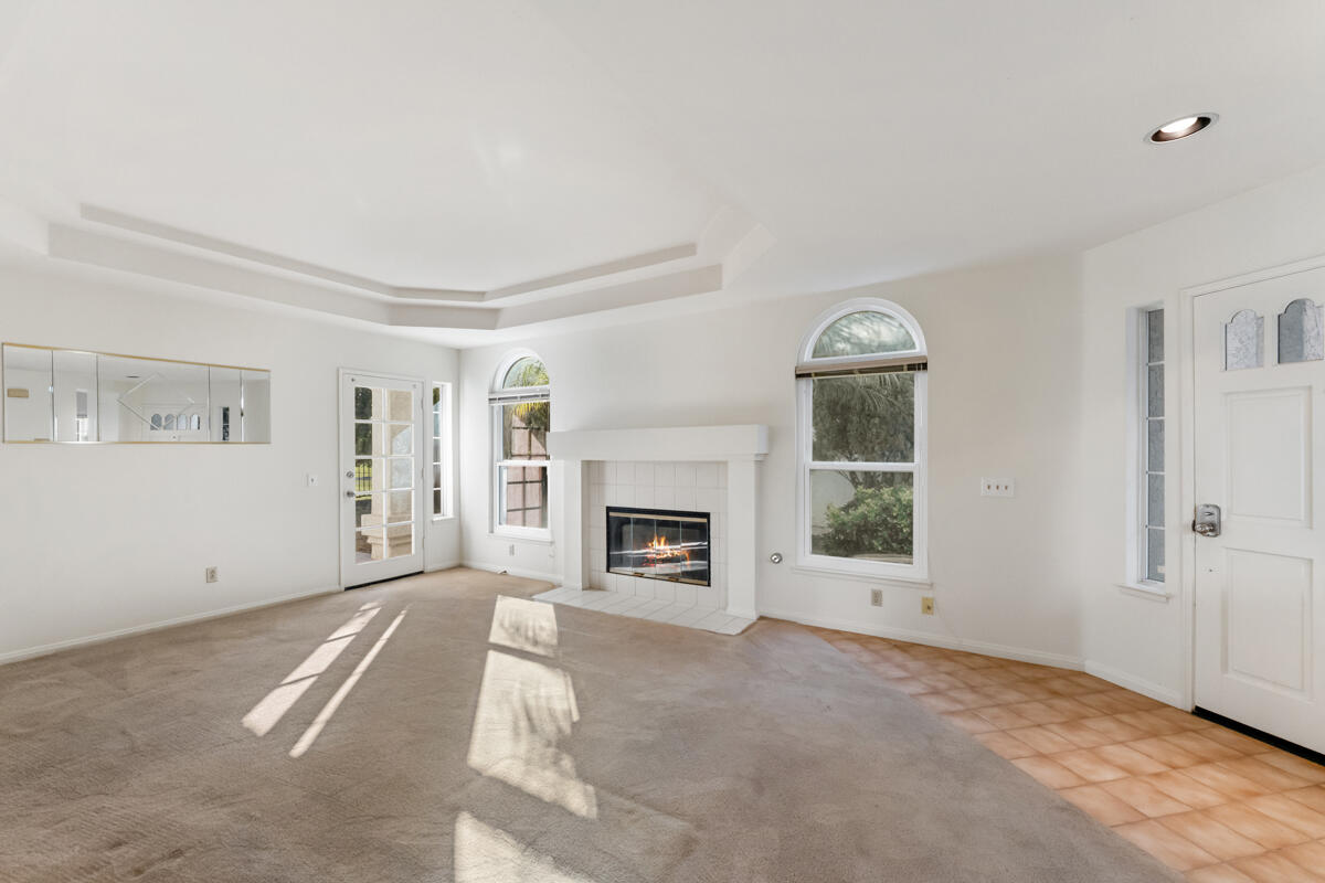 2110 Bermuda Dunes Place Oxnard, CA 93036 - Photo 8 of 43 a view of a livingroom with a fireplace a chandelier and windows