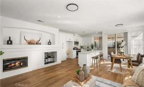 a living room with furniture a fireplace and a flat screen tv