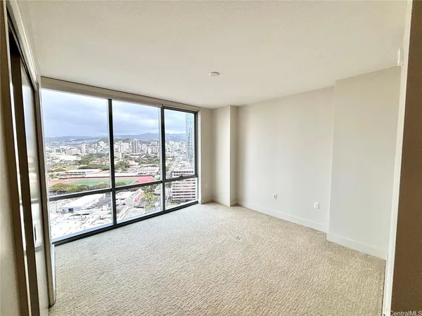 an empty room with large windows