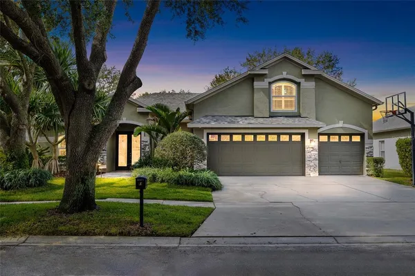 a front view of a house with a yard and garage