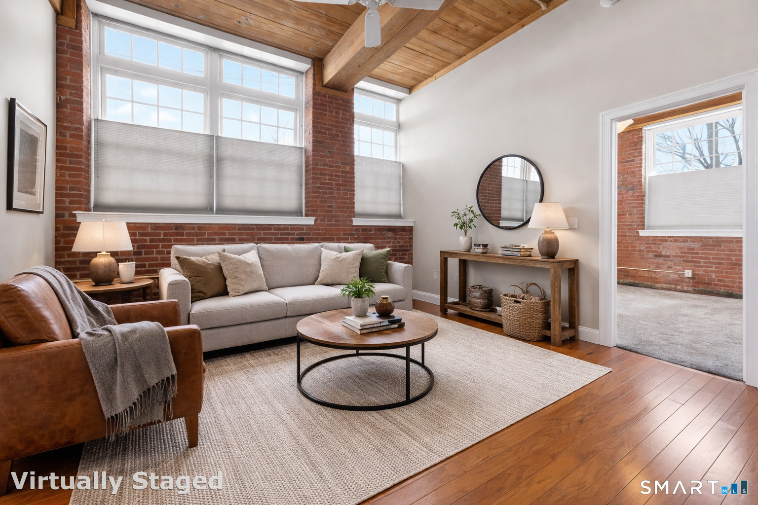 a living room with furniture a fireplace and a large window