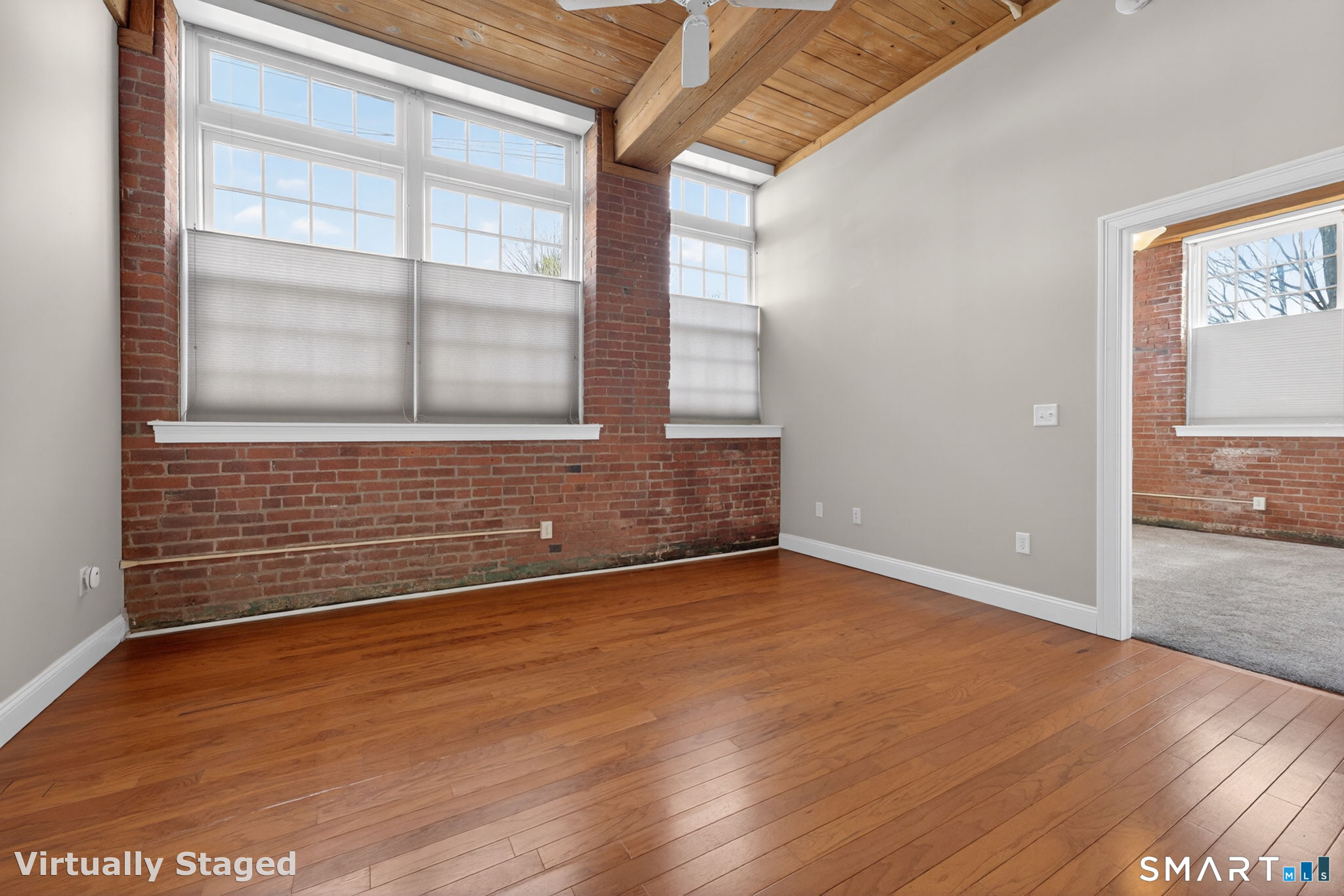 10 Main Street, Unit 102 Berlin, CT 06037 - Photo 10 of 28 a view of an empty room with wooden floor and a window