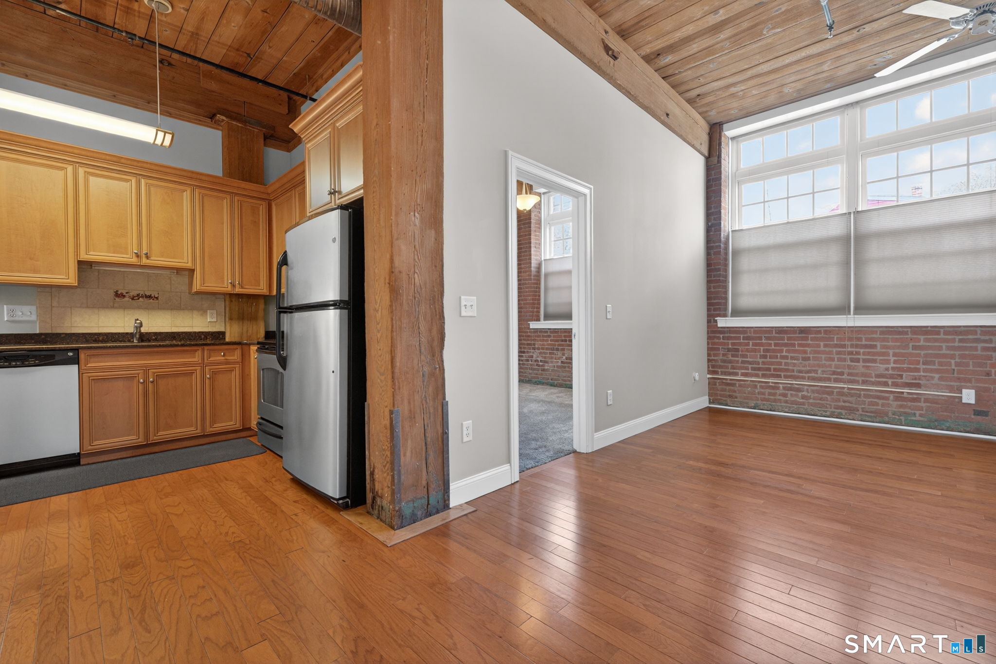 10 Main Street, Unit 102 Berlin, CT 06037 - Photo 5 of 28 a view of a kitchen with a fridge and wooden floor