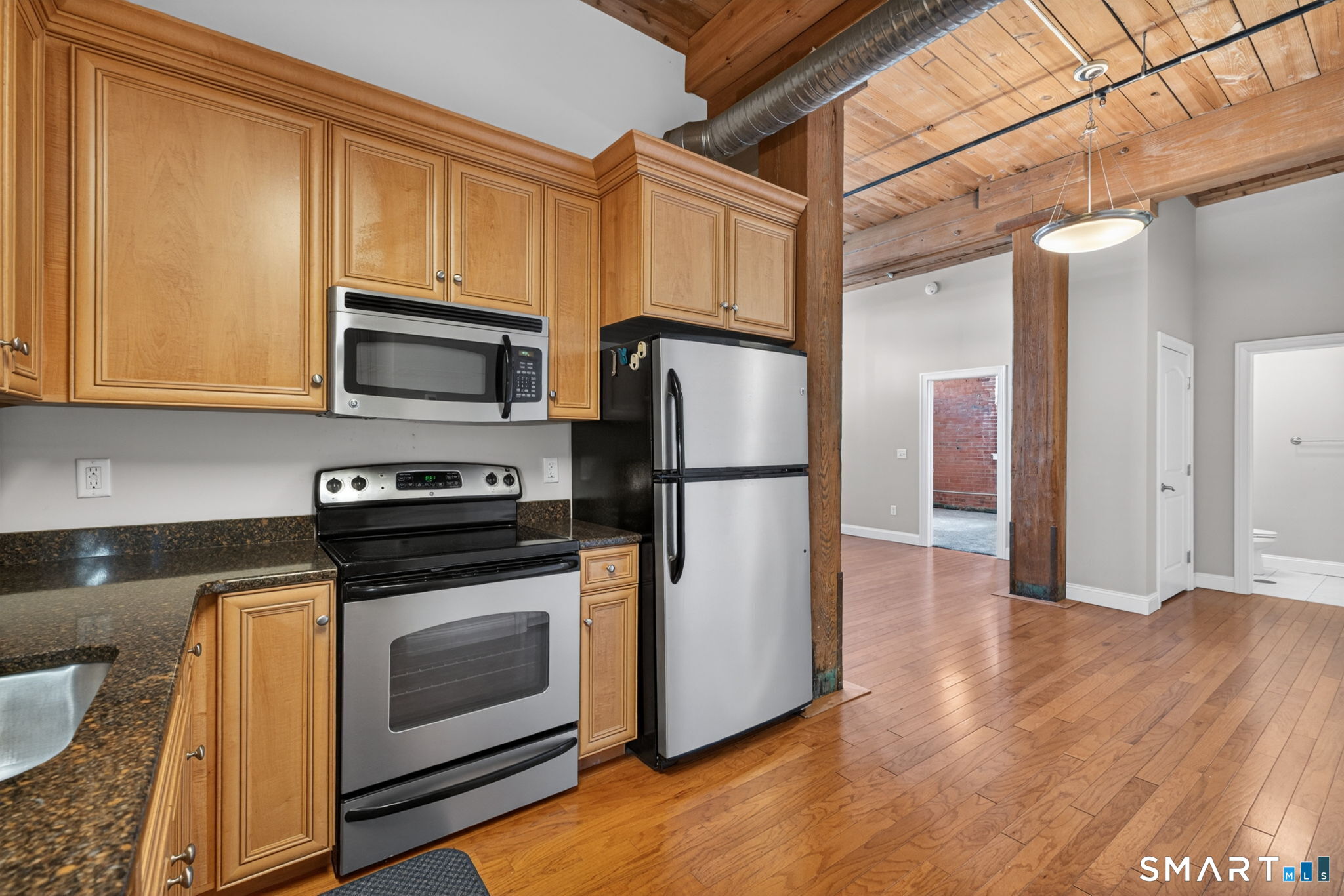 10 Main Street, Unit 102 Berlin, CT 06037 - Photo 8 of 28 a kitchen with a refrigerator stove and microwave
