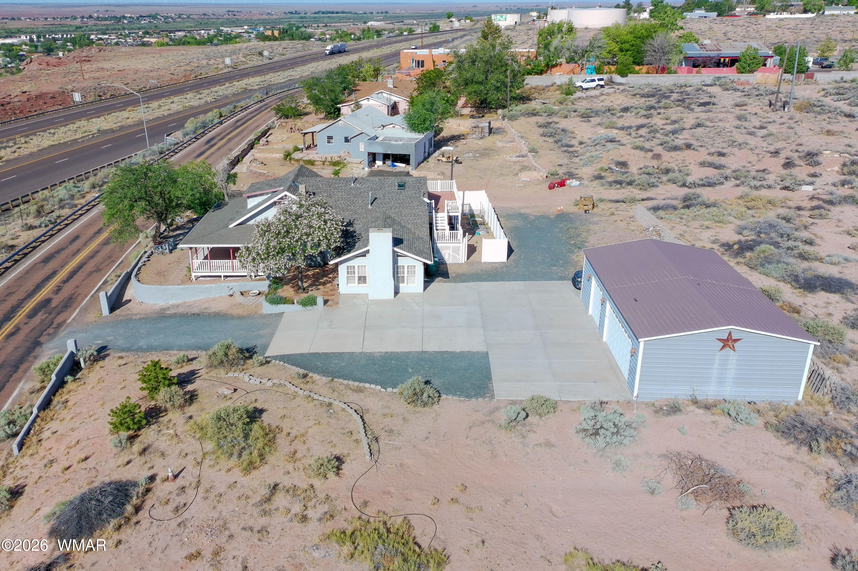 102 Crestview Road Holbrook, AZ 86025 - Photo 52 of 55 an aerial view of a house with a yard and a large parking space