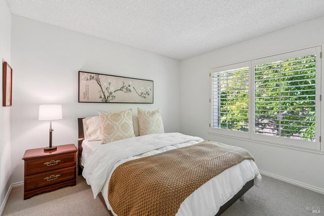 a bedroom with a bed and a night stand