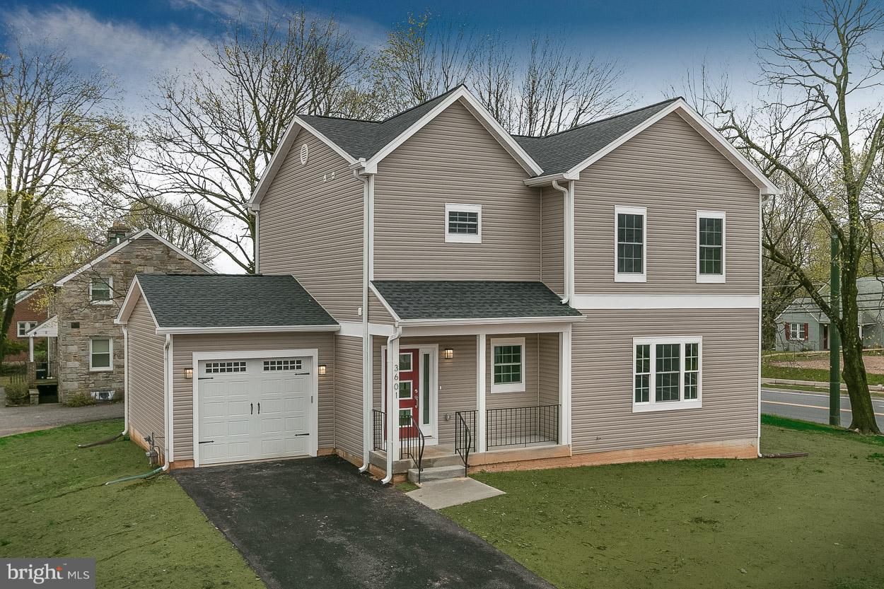 3601 Chapman Road Randallstown, MD 21133 - Photo 2 of 30 a front view of a house with a yard and garage