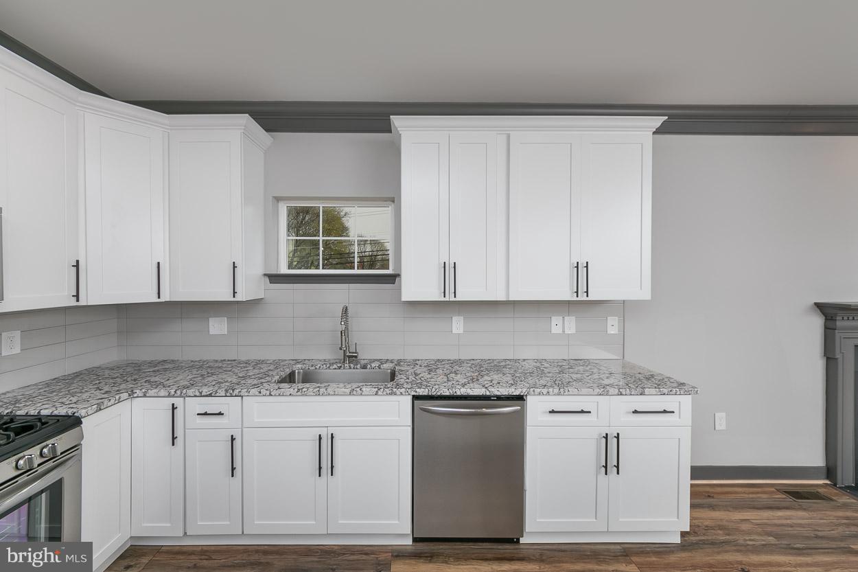 3601 Chapman Road Randallstown, MD 21133 - Photo 11 of 30 a kitchen with granite countertop white cabinets and white appliances