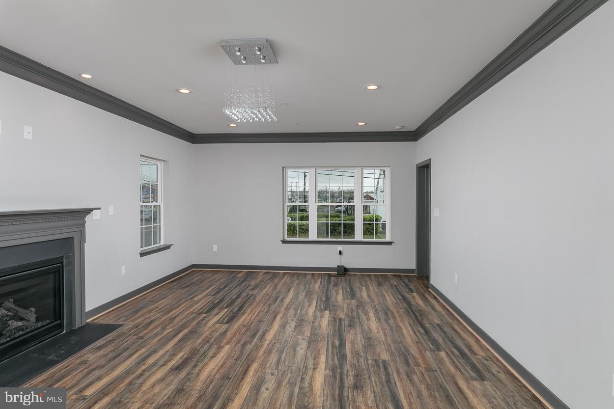 3601 Chapman Road Randallstown, MD 21133 - Photo 13 of 30 a view of an empty room with wooden floor and a window