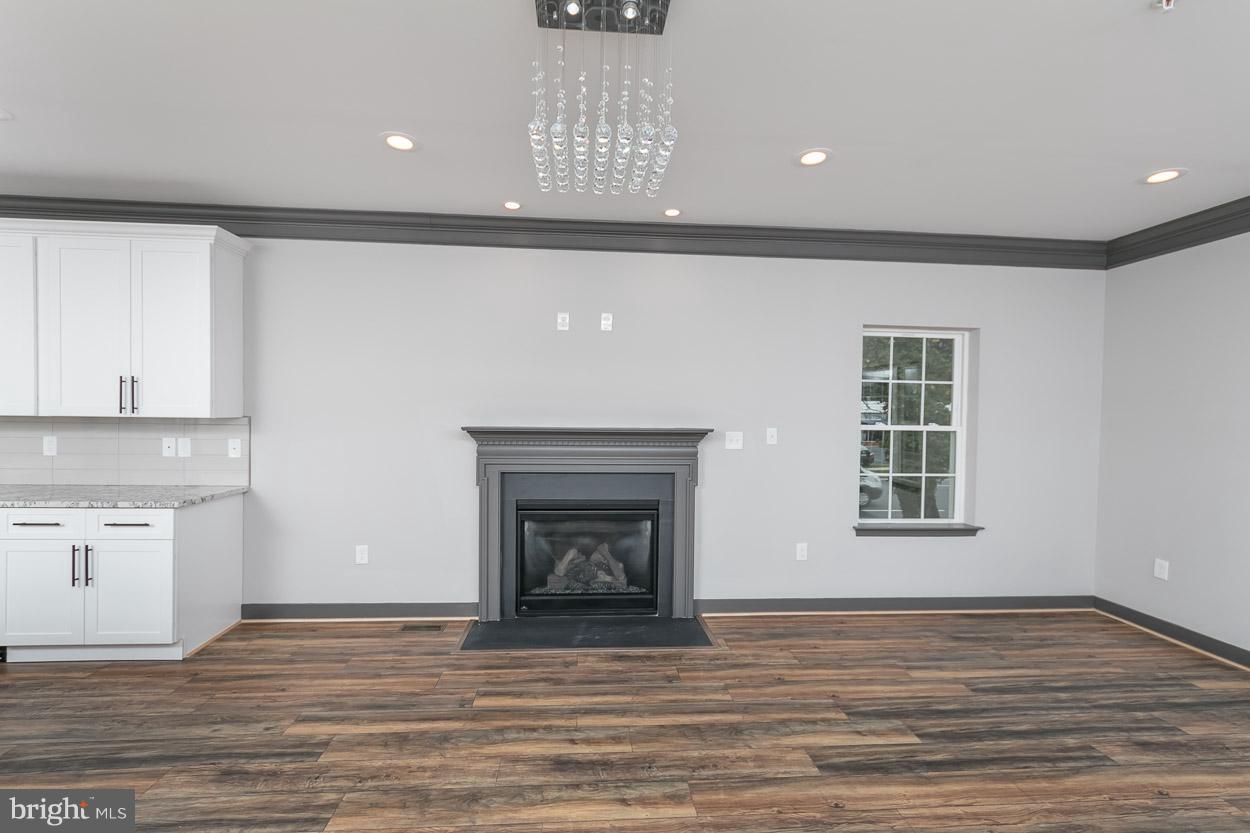 3601 Chapman Road Randallstown, MD 21133 - Photo 14 of 30 a view of an empty room with wooden floor and a window
