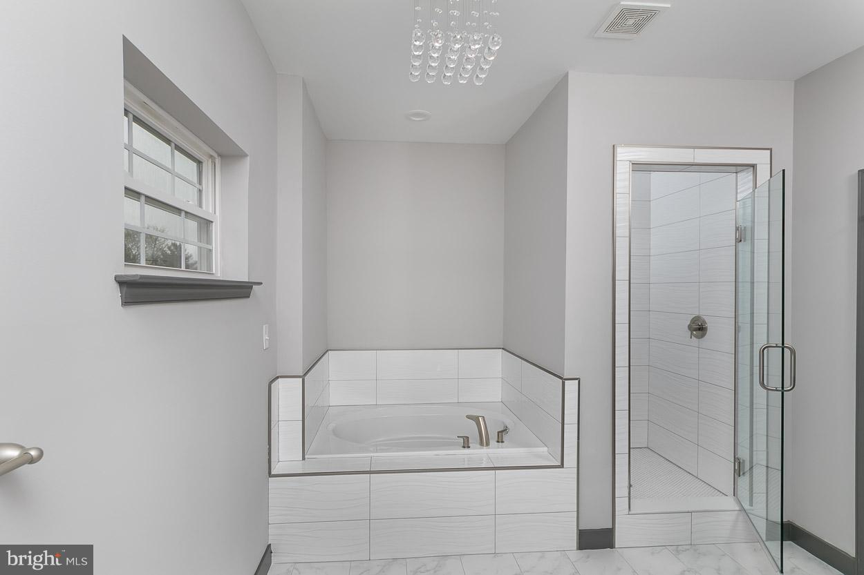 3601 Chapman Road Randallstown, MD 21133 - Photo 18 of 30 a bathroom with a bathtub and a shower