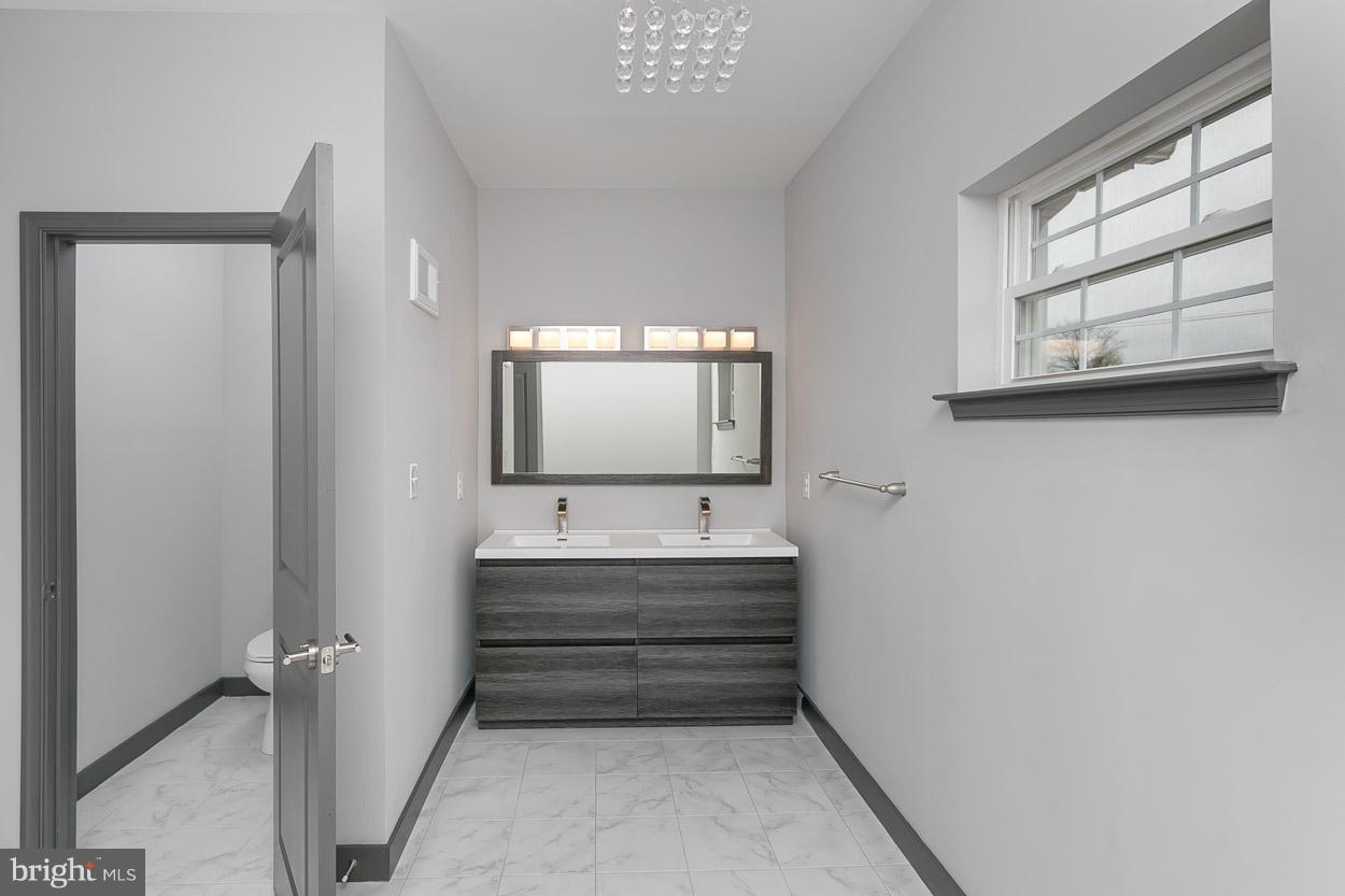 3601 Chapman Road Randallstown, MD 21133 - Photo 20 of 30 a bathroom with a sink and a mirror