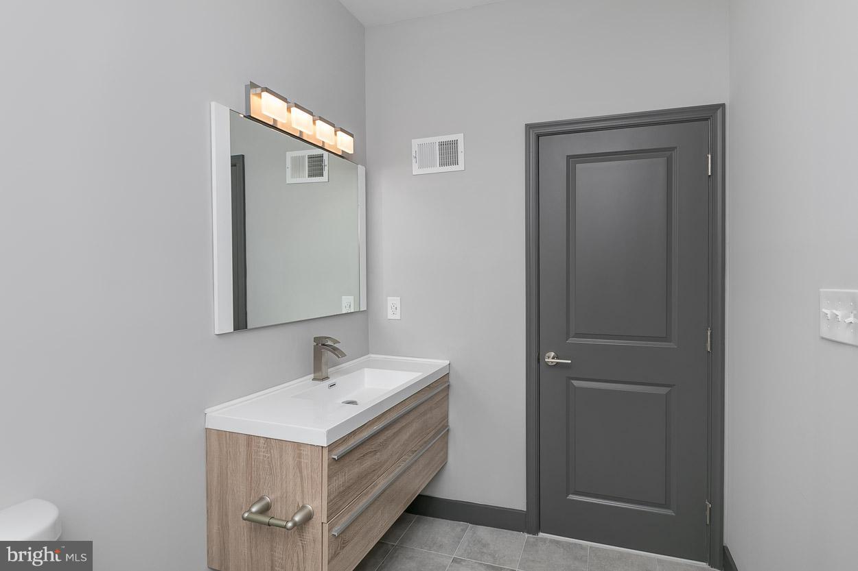 3601 Chapman Road Randallstown, MD 21133 - Photo 22 of 30 a bathroom with a sink and mirror