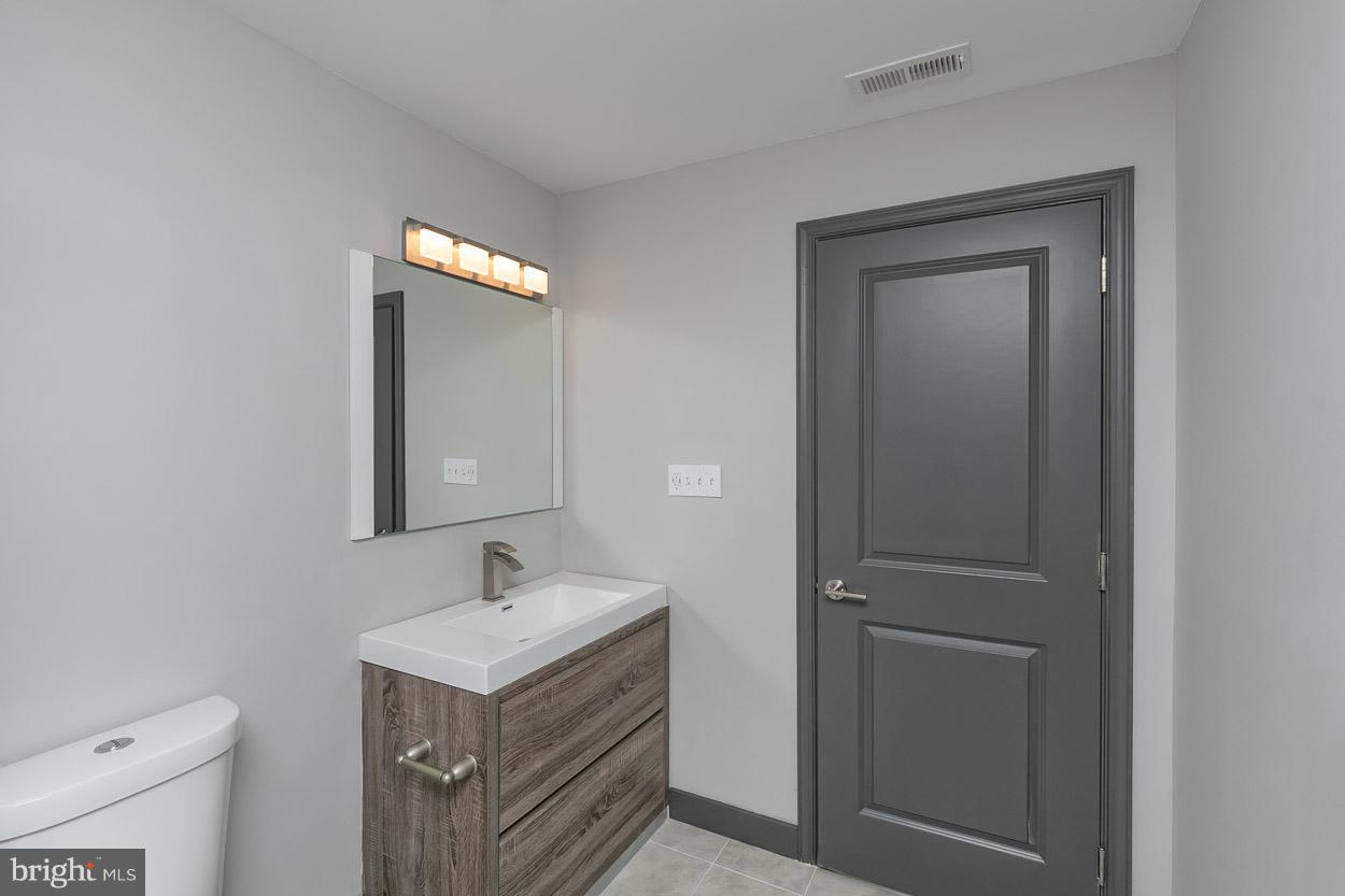 3601 Chapman Road Randallstown, MD 21133 - Photo 28 of 30 a bathroom with a sink toilet and vanity