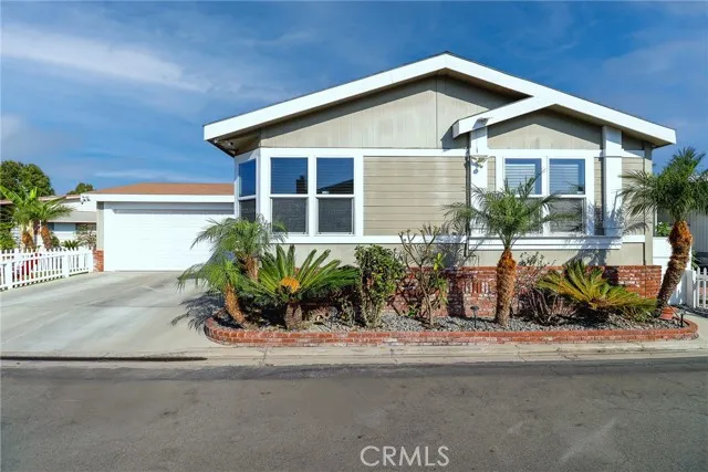 10550 Western, Unit 93 Stanton, CA 90680 - Photo 2 of 34 a front view of a house with a yard and potted plants