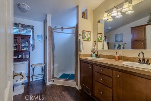10550 Western, Unit 93 Stanton, CA 90680 - Photo 23 of 34 a spacious bathroom with a granite countertop sink a toilet and a mirror