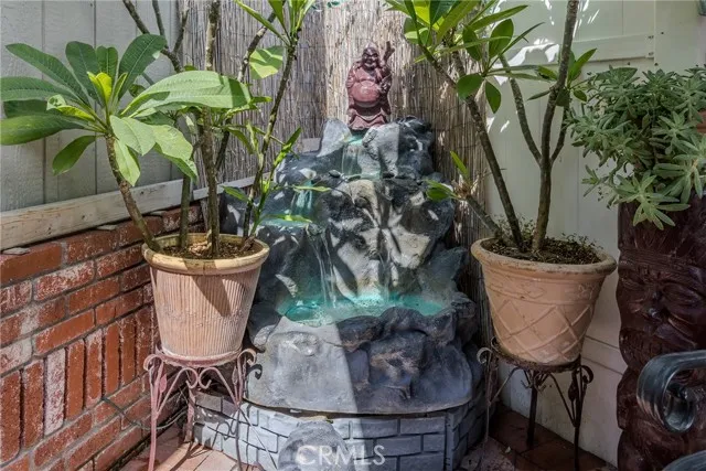 10550 Western, Unit 93 Stanton, CA 90680 - Photo 29 of 34 a table with a potted plant and a vase of flowers