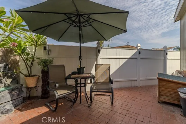 10550 Western, Unit 93 Stanton, CA 90680 - Photo 30 of 34 a blue and white table and chair under an umbrella