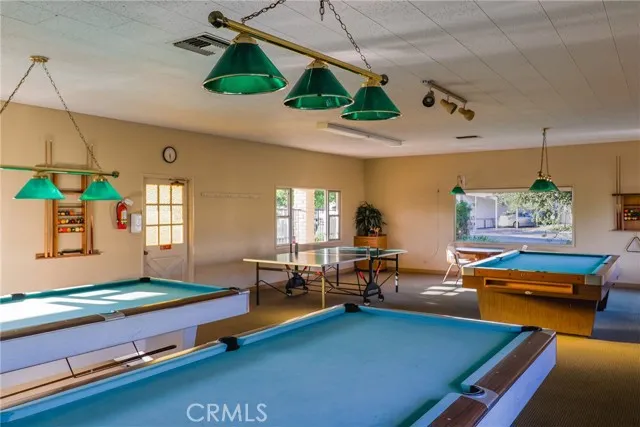 10550 Western, Unit 93 Stanton, CA 90680 - Photo 33 of 34 a living room with furniture pool table and chairs