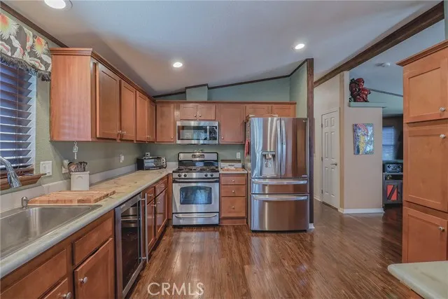 10550 Western, Unit 93 Stanton, CA 90680 - Photo 7 of 34 a kitchen with stainless steel appliances a refrigerator sink and microwave