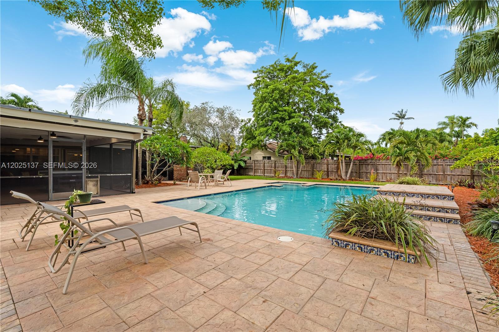 11480 Southwest 96th Terrace Miami, FL 33176 - Photo 50 of 54 a view of swimming pool with lounge chair and dinning table under an umbrella