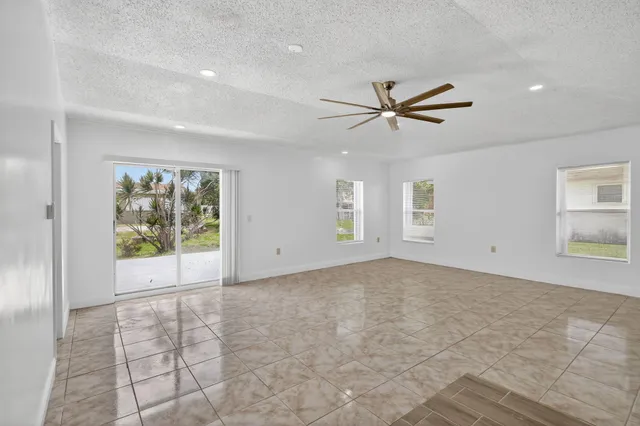 a view of a livingroom with a ceiling fan & window