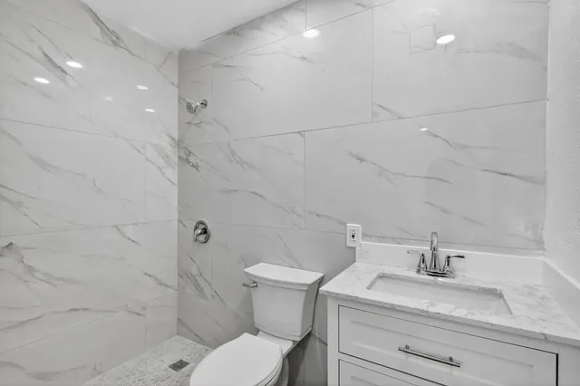 an empty room with a window and a ceiling fan