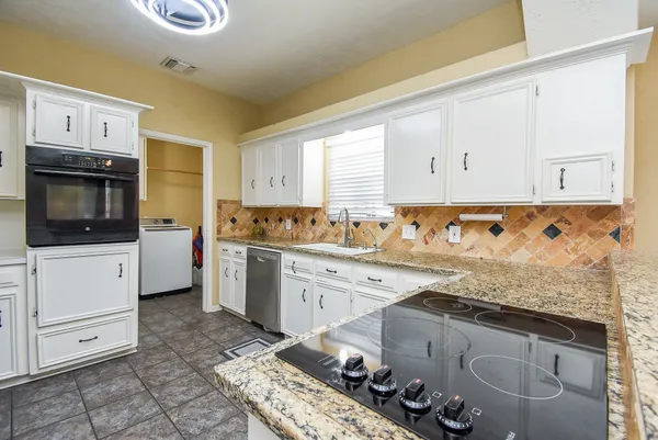 a kitchen with a sink stove and cabinets