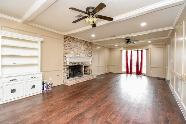 a view of an empty room with a fireplace and a window