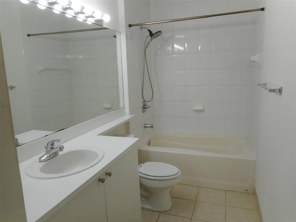7970 North Nob Hill Road, Unit 207 Tamarac, FL 33321 - Photo 11 of 22 a bathroom with a sink a toilet and shower