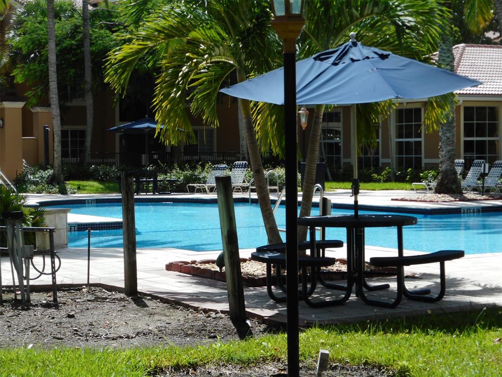 7970 North Nob Hill Road, Unit 207 Tamarac, FL 33321 - Photo 15 of 22 a view of a chairs and table in patio