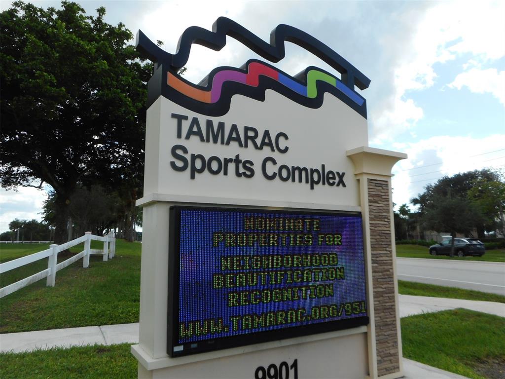 7970 North Nob Hill Road, Unit 207 Tamarac, FL 33321 - Photo 18 of 22 a sign on the side of the road