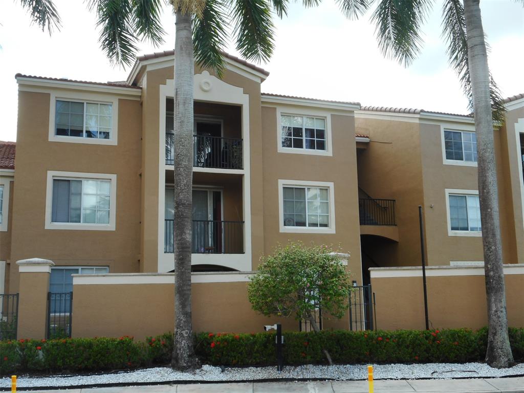 7970 North Nob Hill Road, Unit 207 Tamarac, FL 33321 - Photo 2 of 22 a front view of a house with balcony