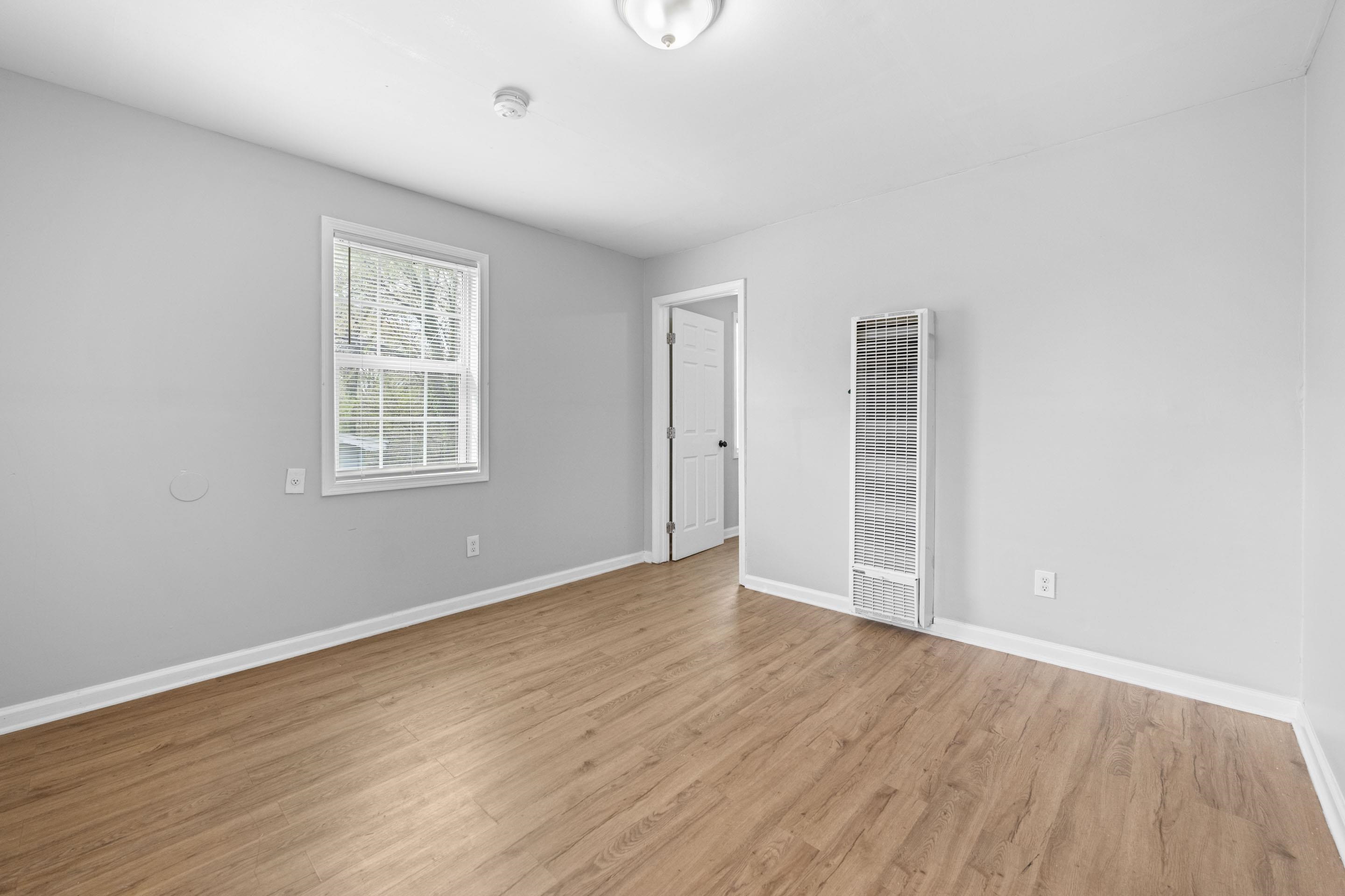 1493 Gaither Street Memphis, TN 38106 - Photo 15 of 27 an empty room with wooden floor and windows