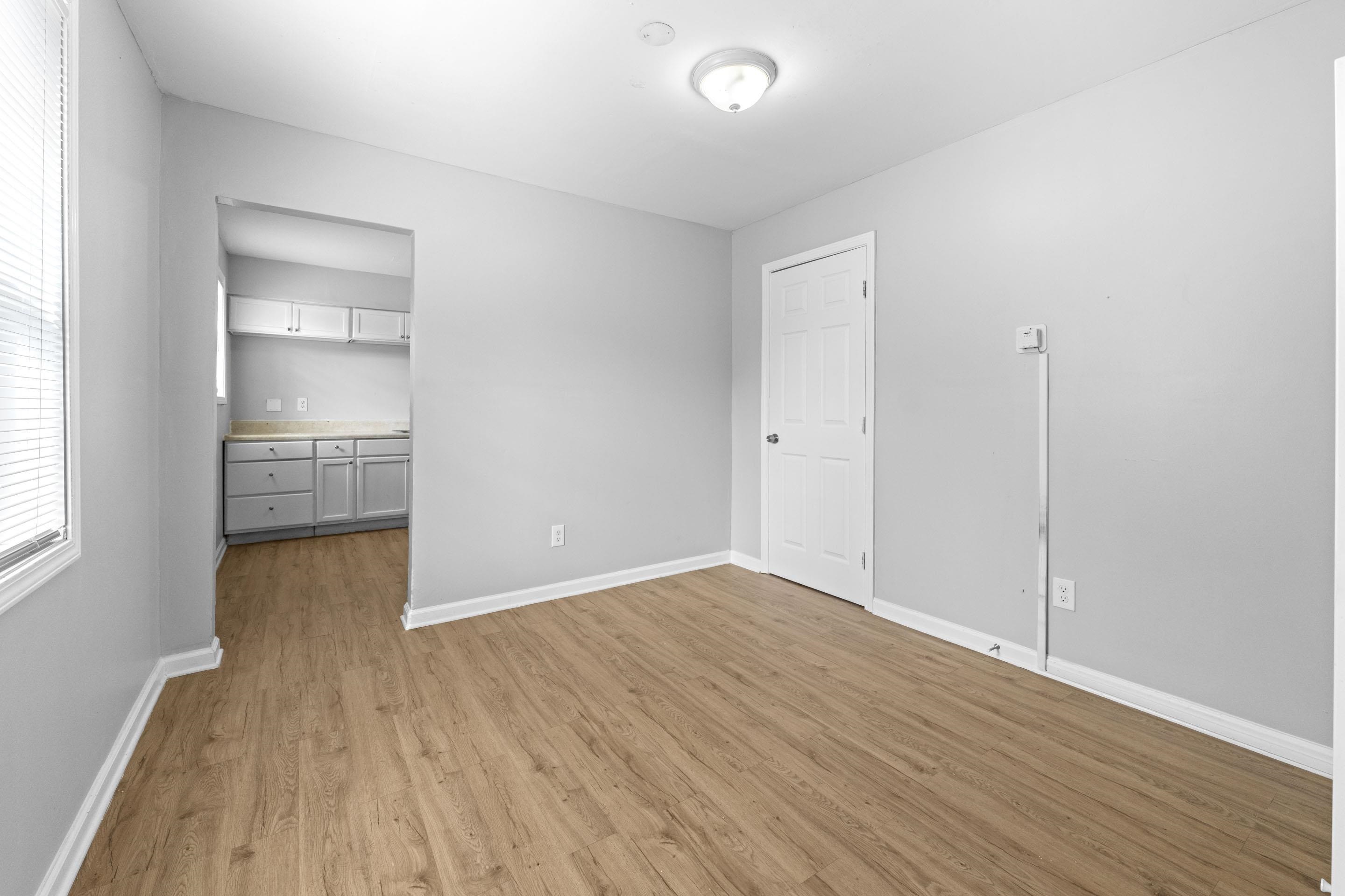 1493 Gaither Street Memphis, TN 38106 - Photo 16 of 27 wooden floor in an empty room with a window