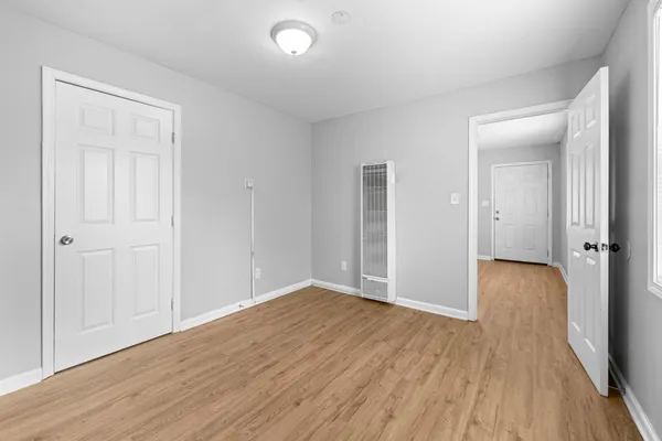 a kitchen with a cabinets and wooden floor
