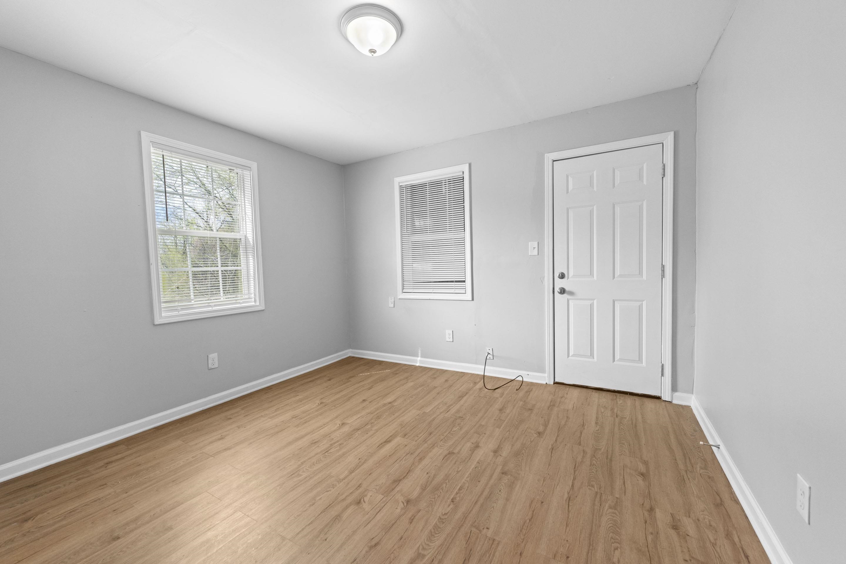 1493 Gaither Street Memphis, TN 38106 - Photo 20 of 27 a view of an empty room with wooden floor and a window