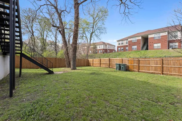 a view of a house with a backyard